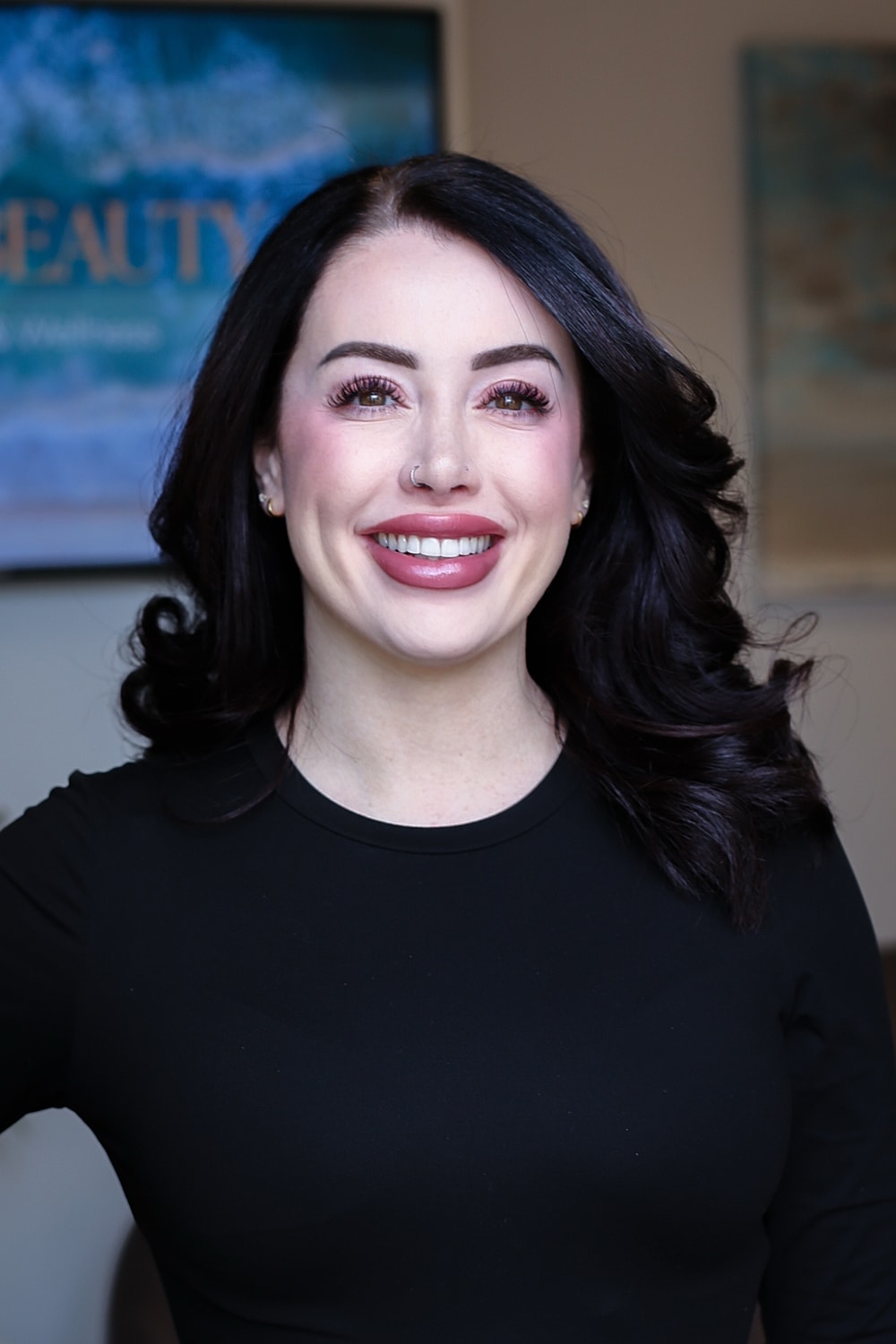 Smiling woman with dark hair and black shirt.