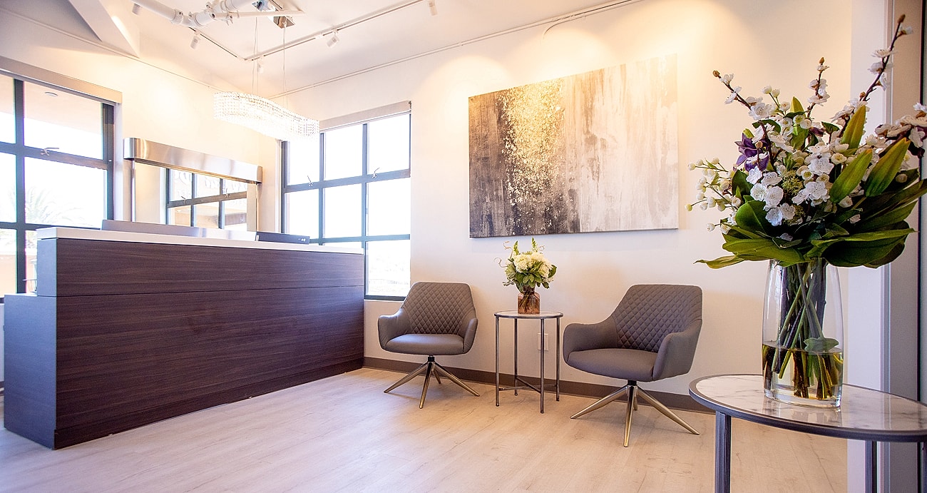 Modern waiting area with elegant decor and flowers.
