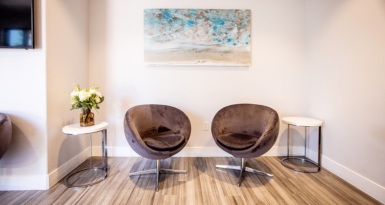 Modern seating area with abstract wall art.