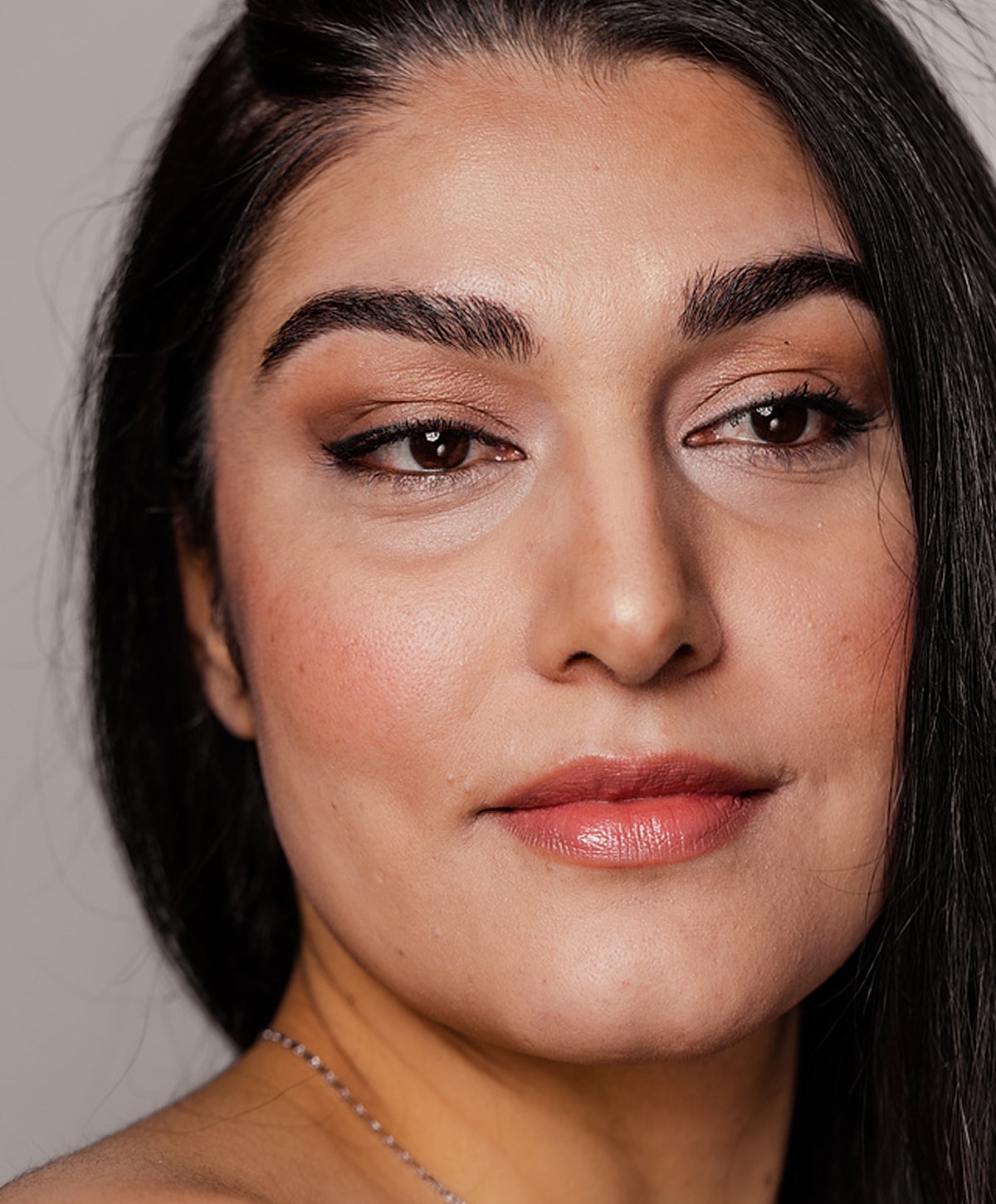 Close-up of a woman's face and smile.