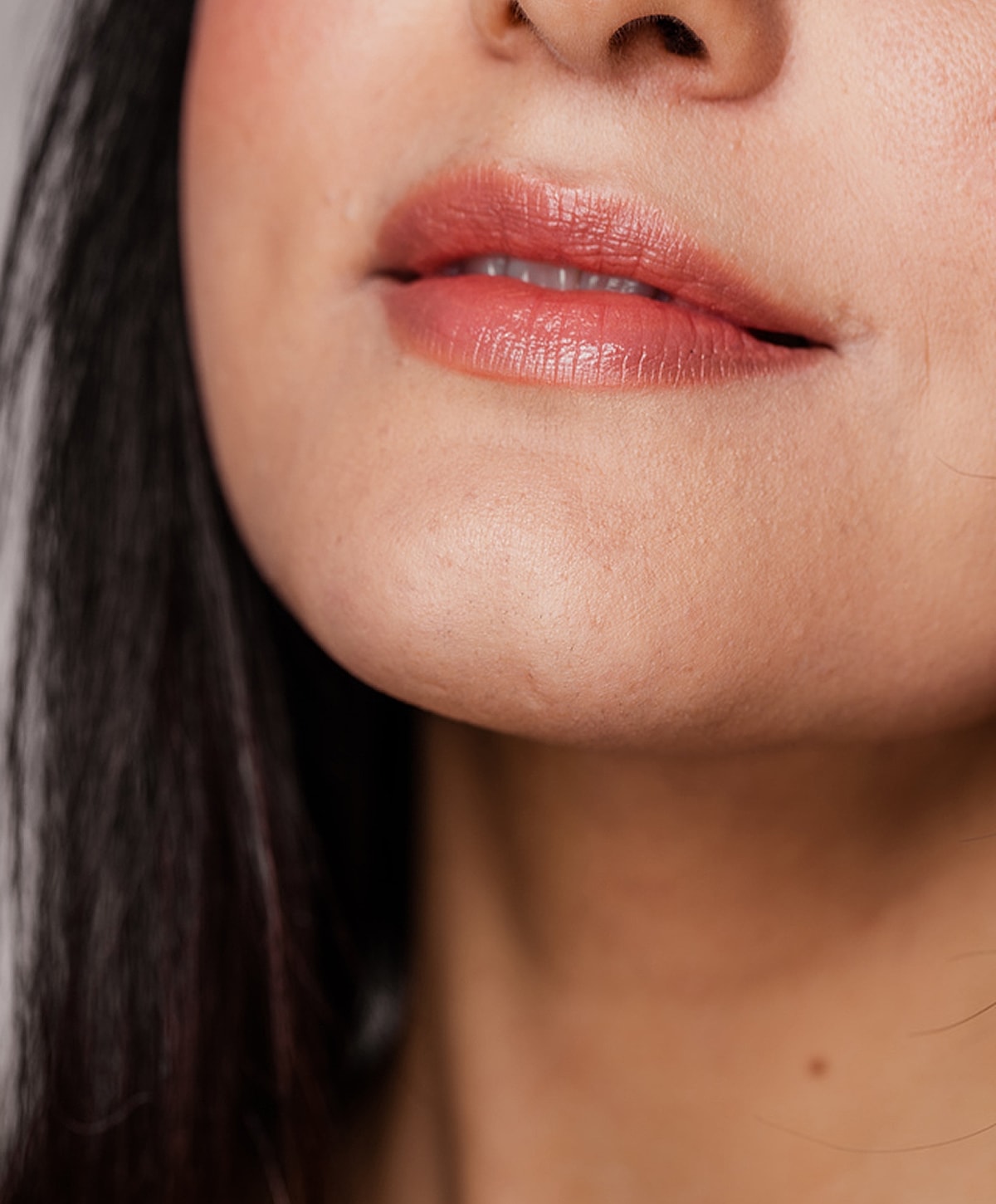 Close-up of a woman's face and smile.