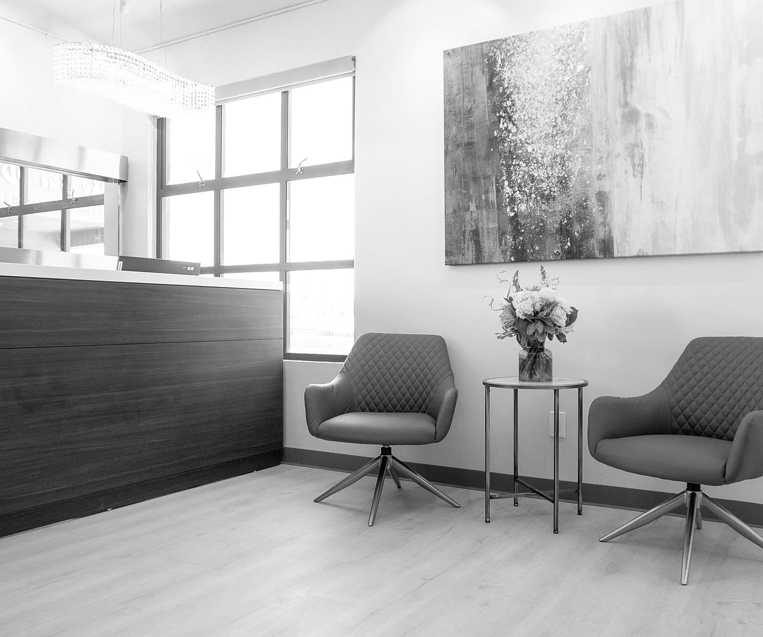 Modern waiting area with gray chairs and decor.