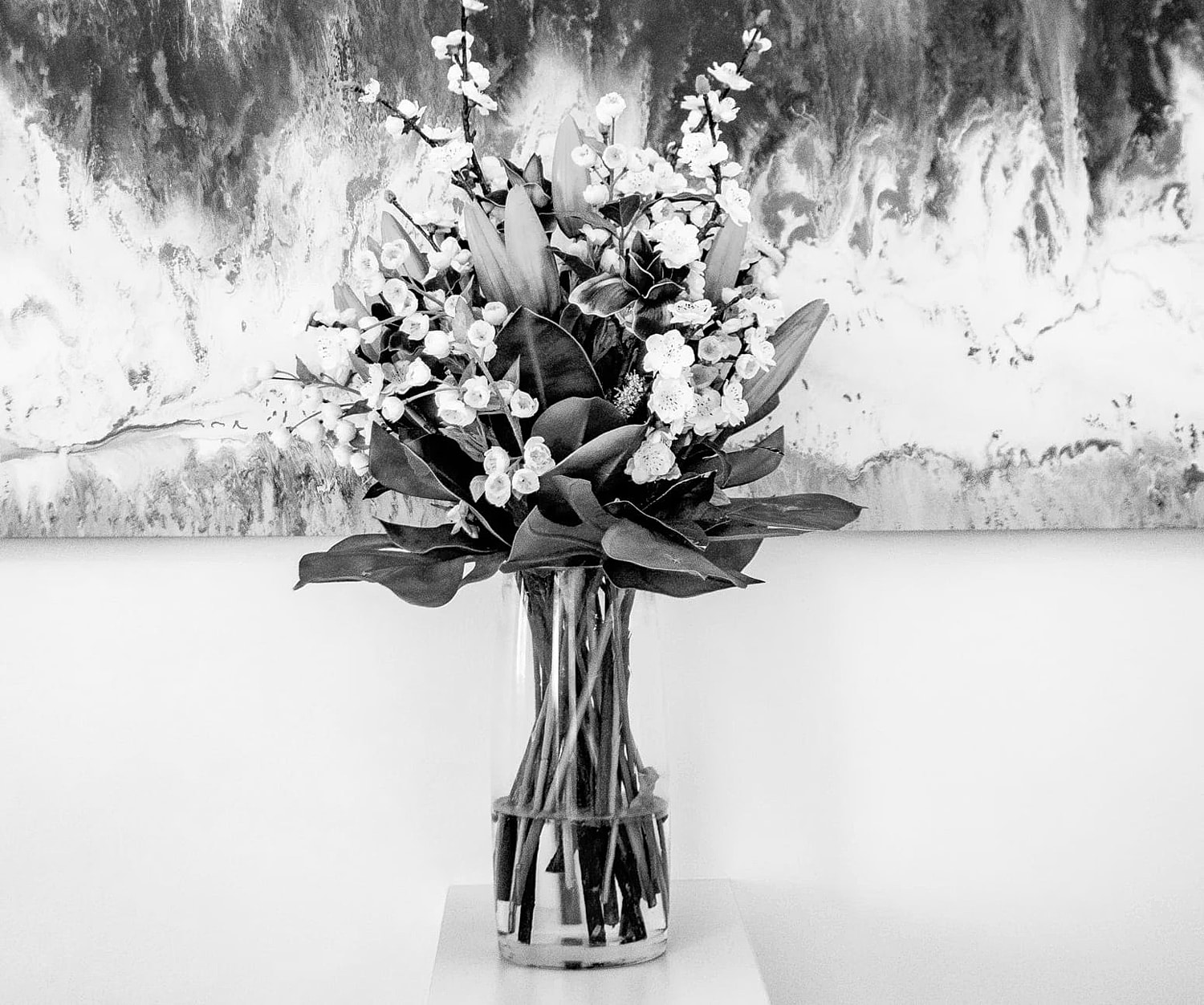 Black and white bouquet in a glass vase.