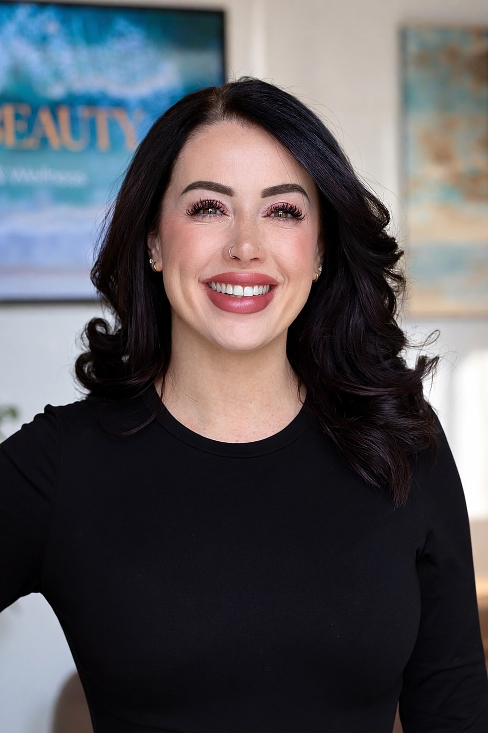 Smiling woman with dark hair and black shirt.