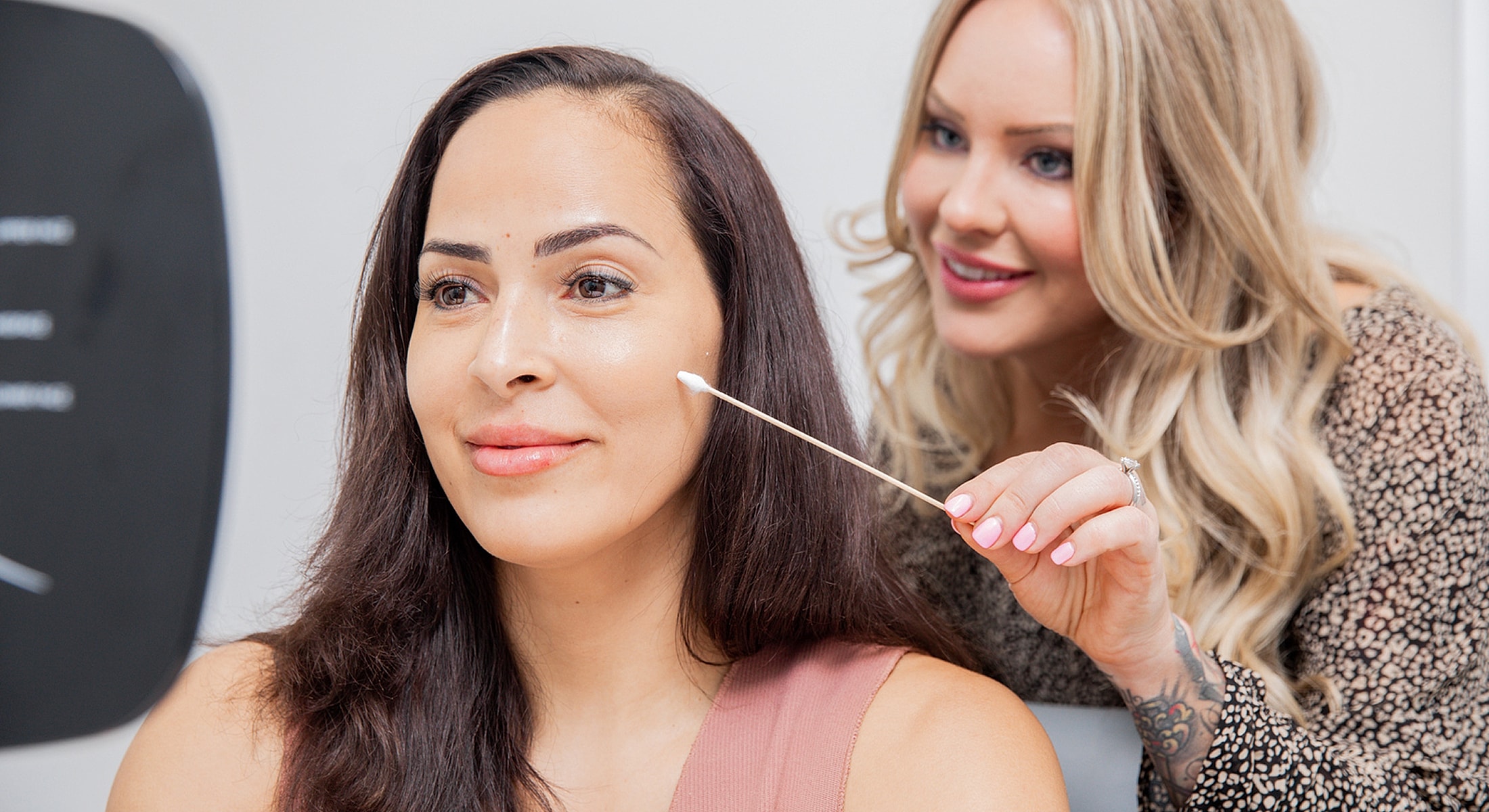 Beauty treatment in progress with client and technician.