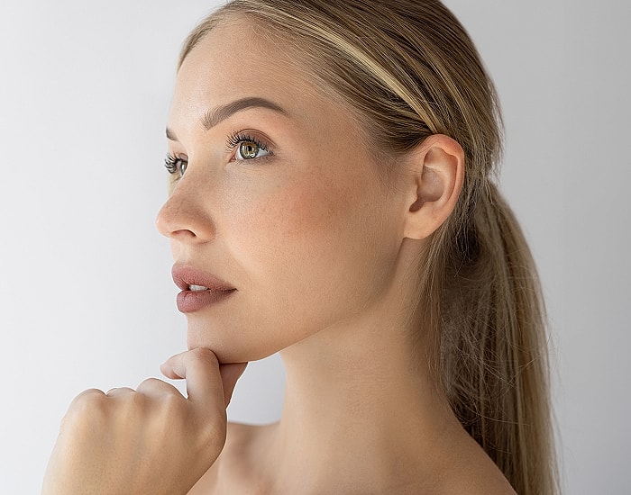 Profile of a contemplative woman with light makeup