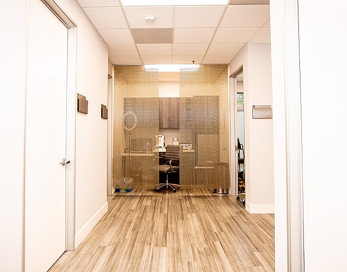 Modern office hallway with glass partition.